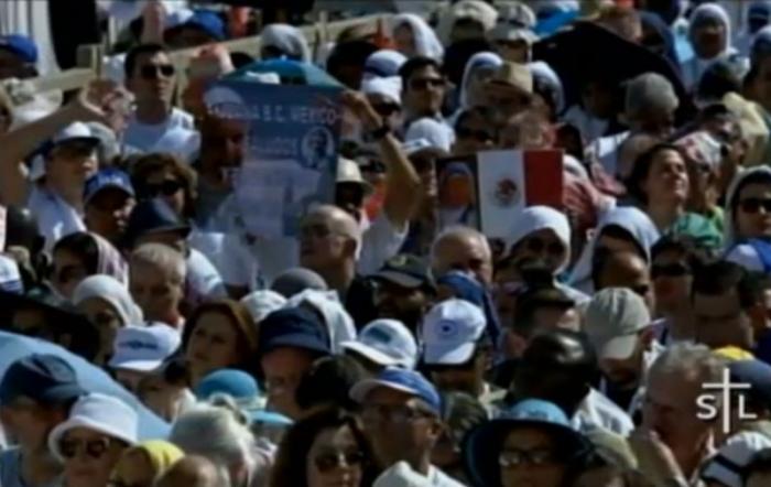 Members of the crowd had flags and banners to celebrate St. Teresa.