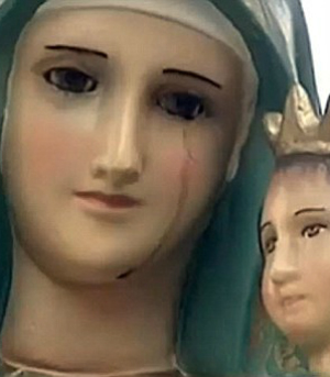 A MIRACLE? Virgin Mary statue with single red tear sparks mass ... pic