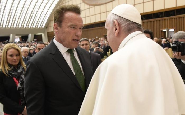 Pope Francis greets Arnold Schwarzenegger during his general audience.