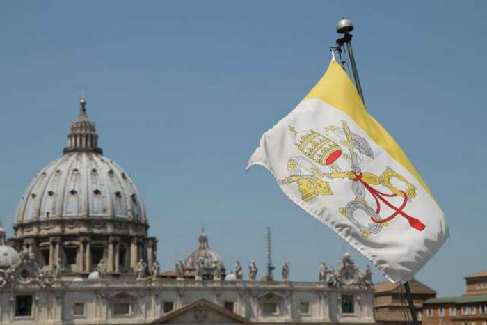 A view of St. Peter's Basilica and Vatican City Flag.