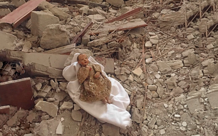 The Christ Child lies amid the rubble of the monastery in Camerino, Italy.