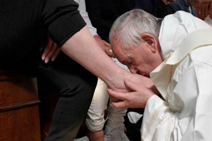 Pope Francis kisses the feet of an inmate at Paliano prison during Holy Thursday Mass April 13.